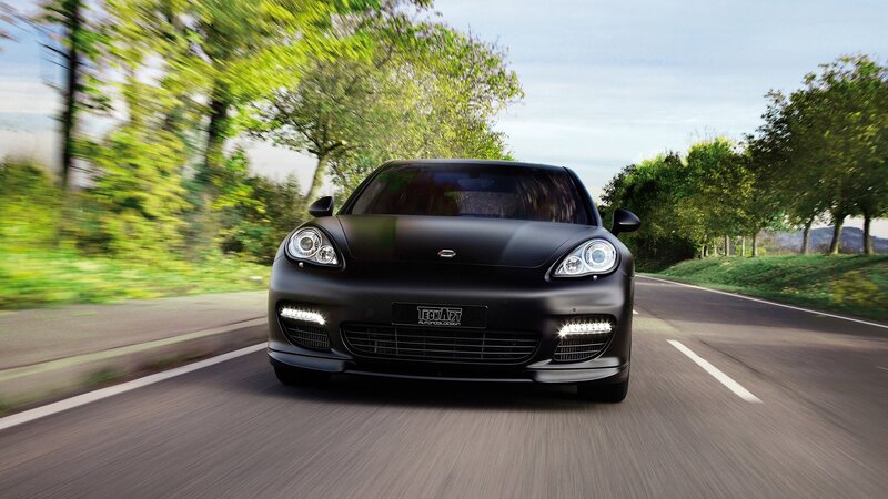 black car driving on road