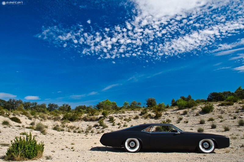 Black car in desert landscape