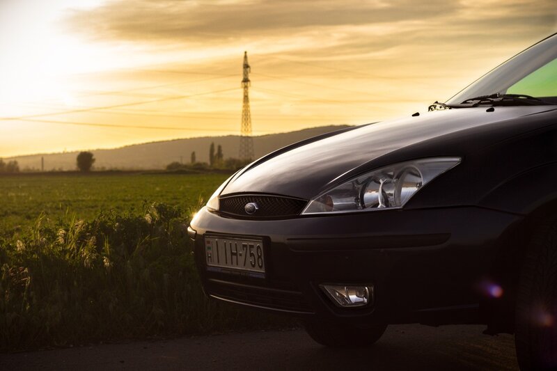 Black Car in Field — Serene