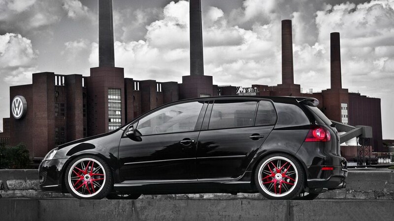 Black car in front of factory