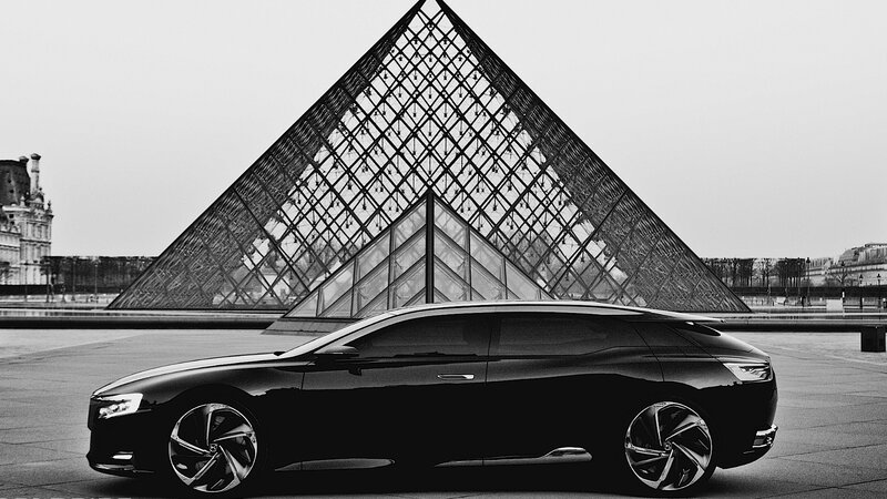 Black car in front of Louvre pyramid