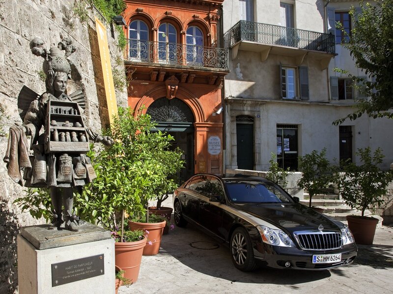 Black car in front of perfume museum