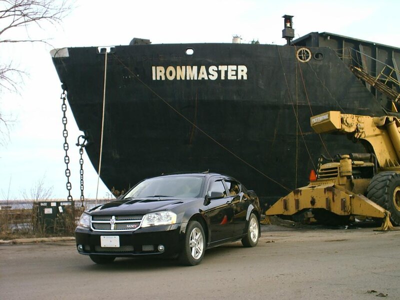 Black car in front of ship