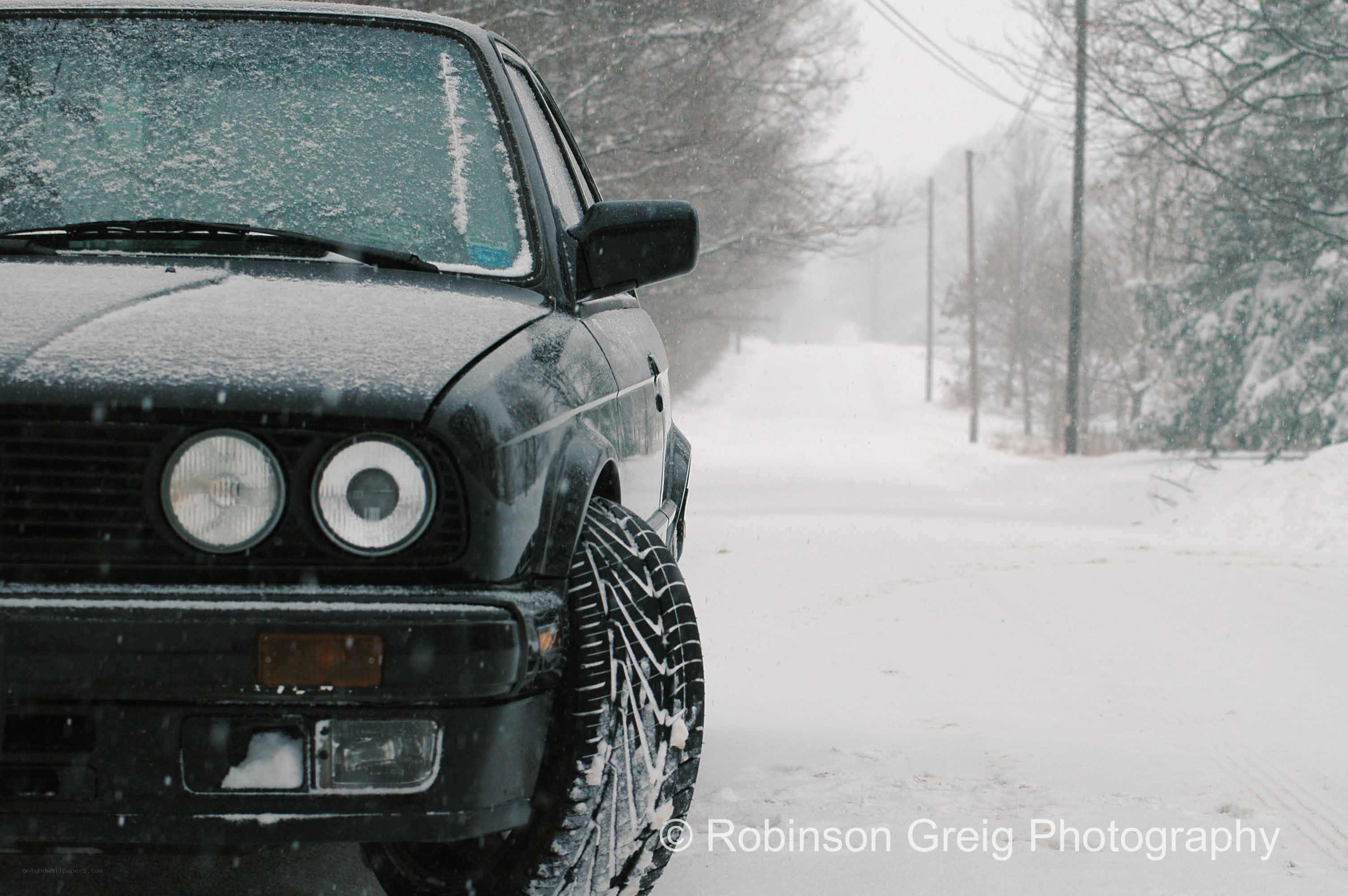 Black car in snowy landscape