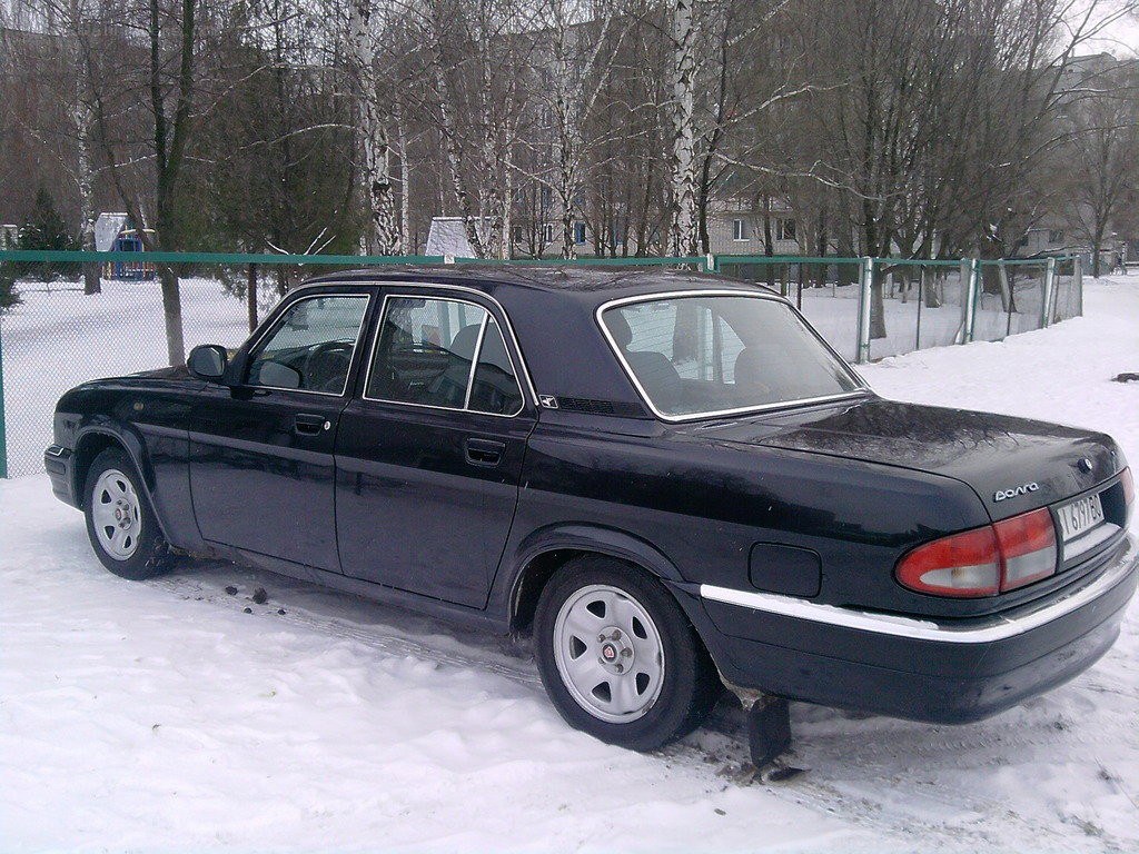 black car in snowy yard