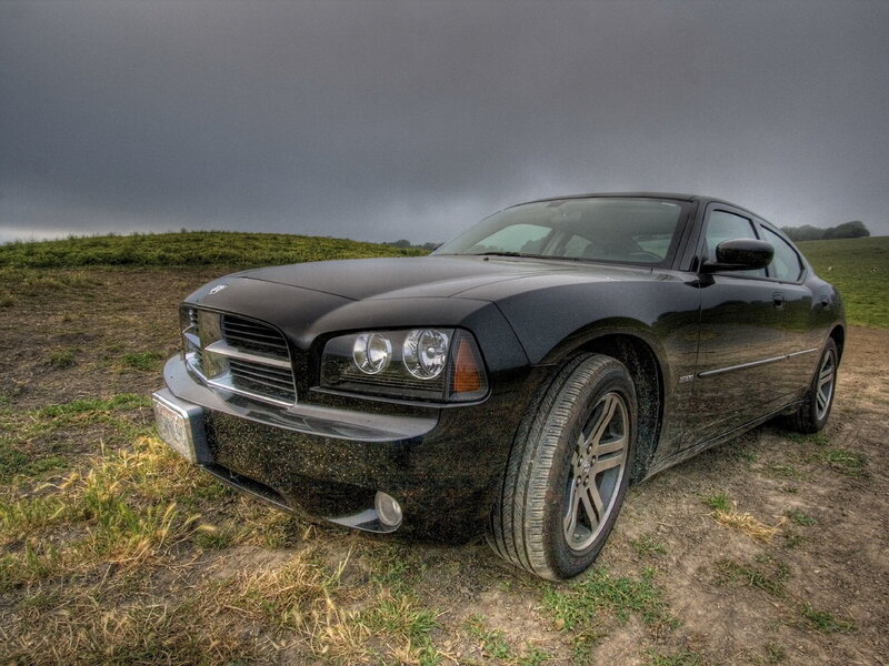 Black car on a dirt field