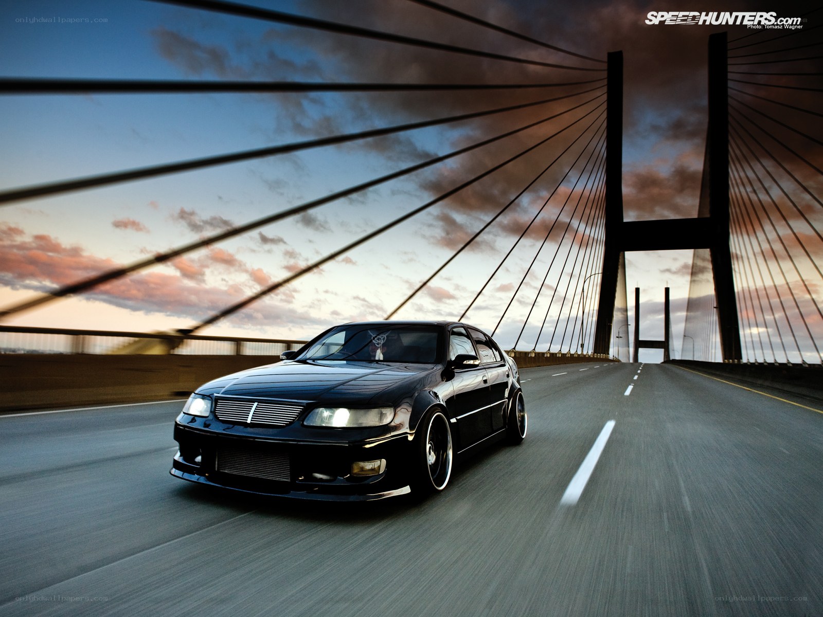 black car on cable-stayed bridge