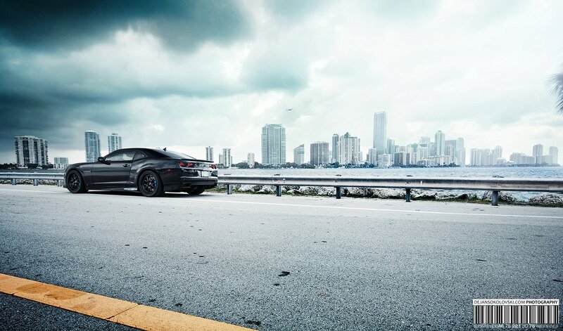 Black car on coastal road