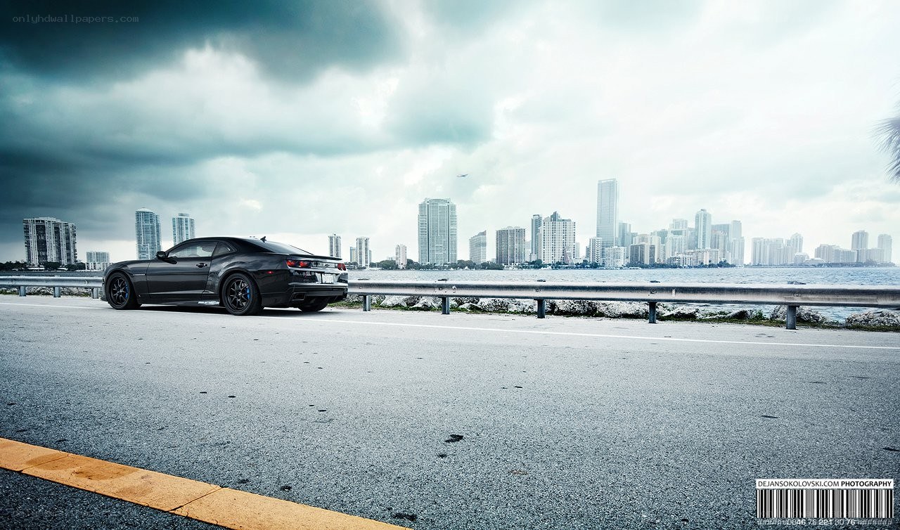 Black car on coastal road