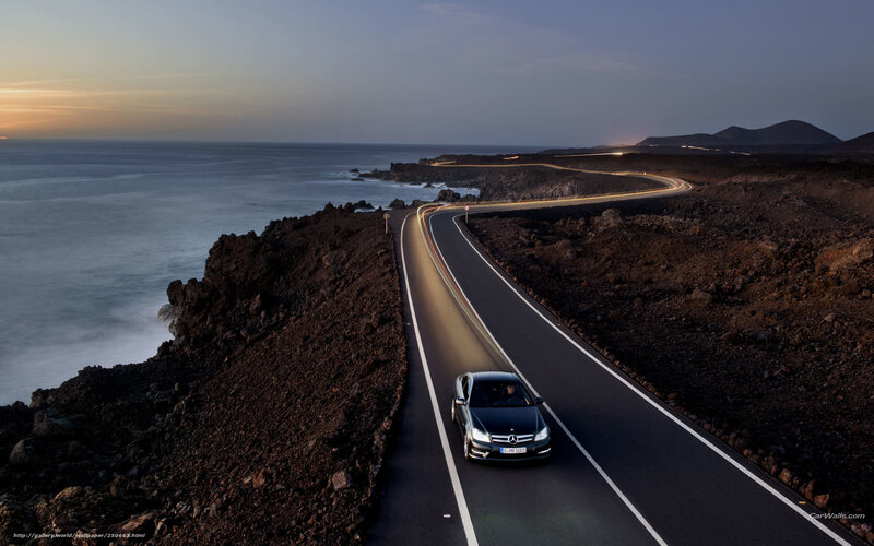Black Car on Coastal Road — Dramatic