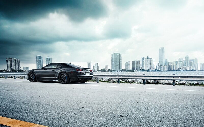 Black car on coastal road