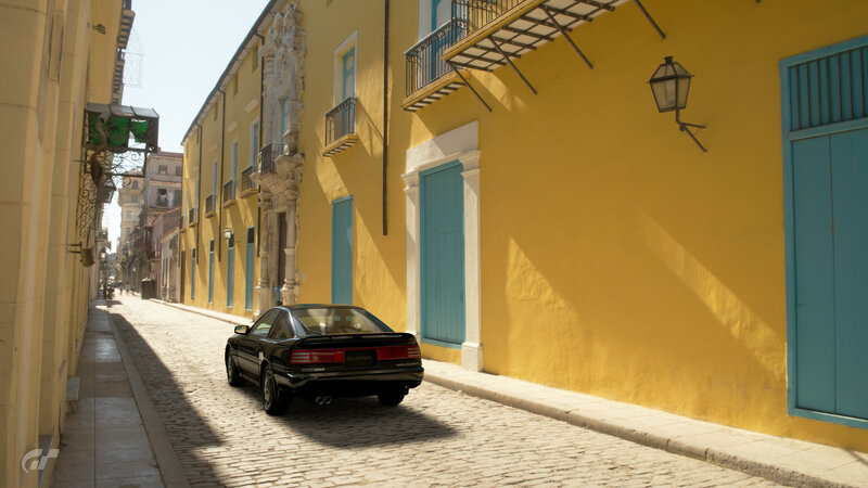 Black Car on Cobblestone Street — Yellow