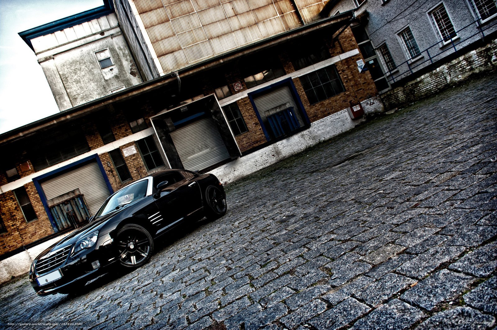 Black car on cobblestone street