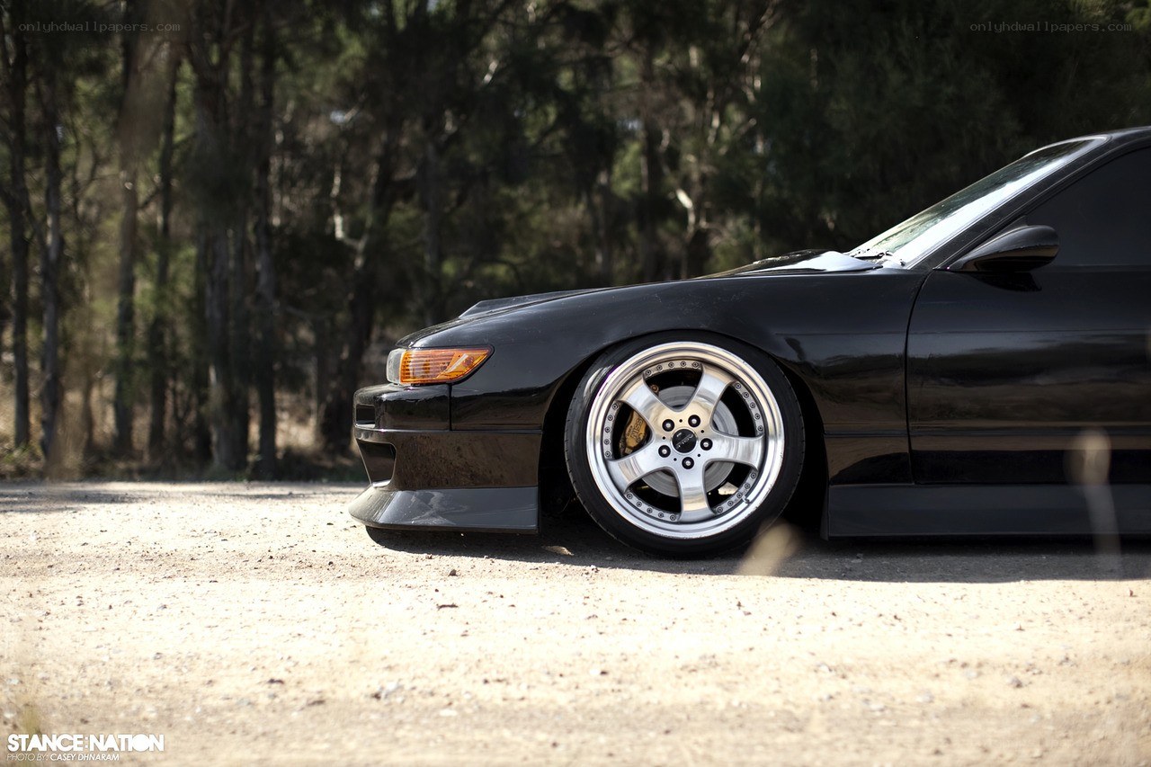 black car on dirt road