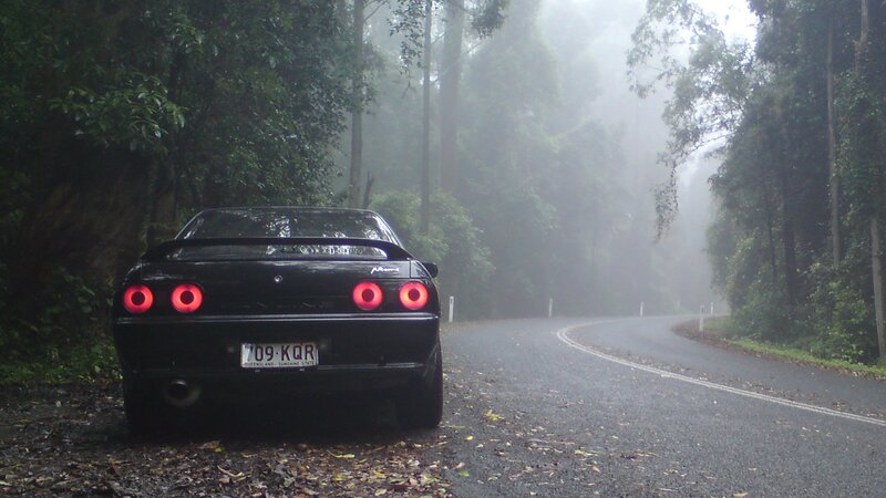 Black car on foggy road