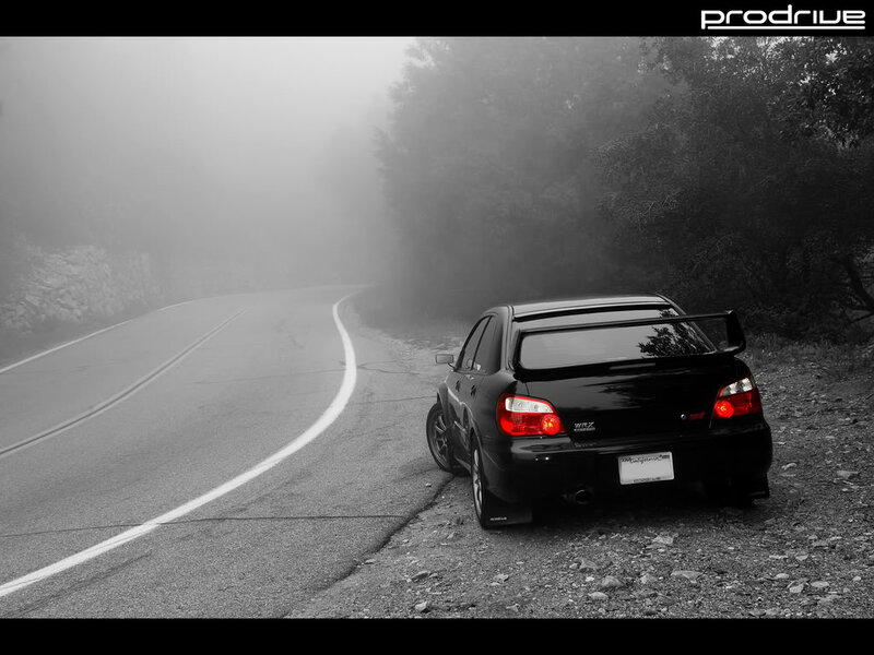Black car on foggy road