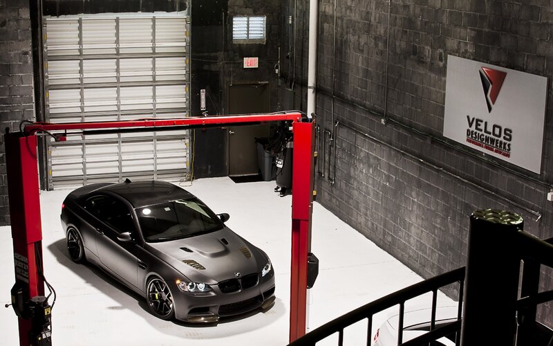 Black car on lift in garage