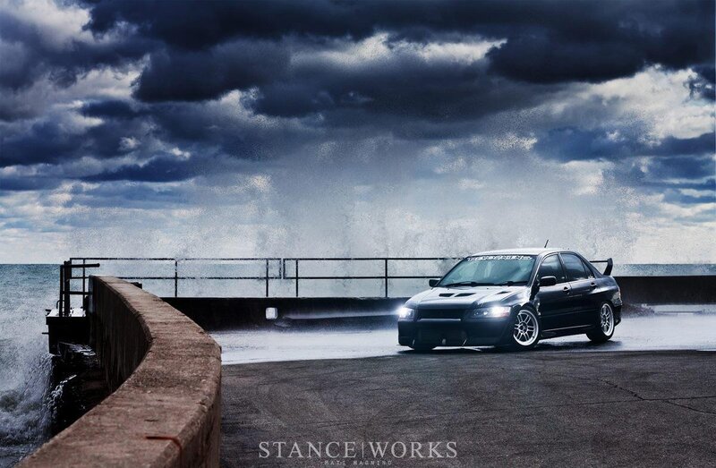 Black car on pier in storm