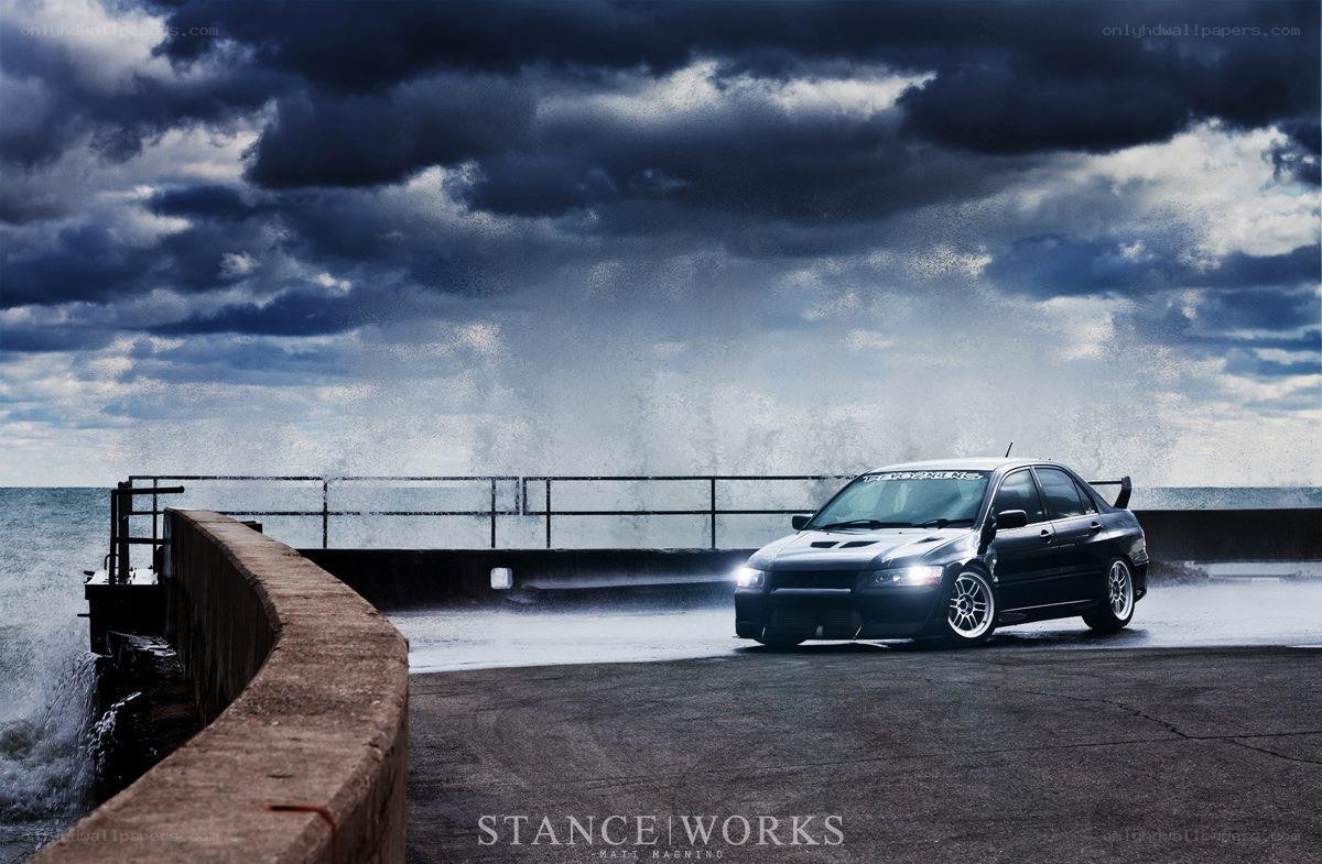 Black car on pier in storm