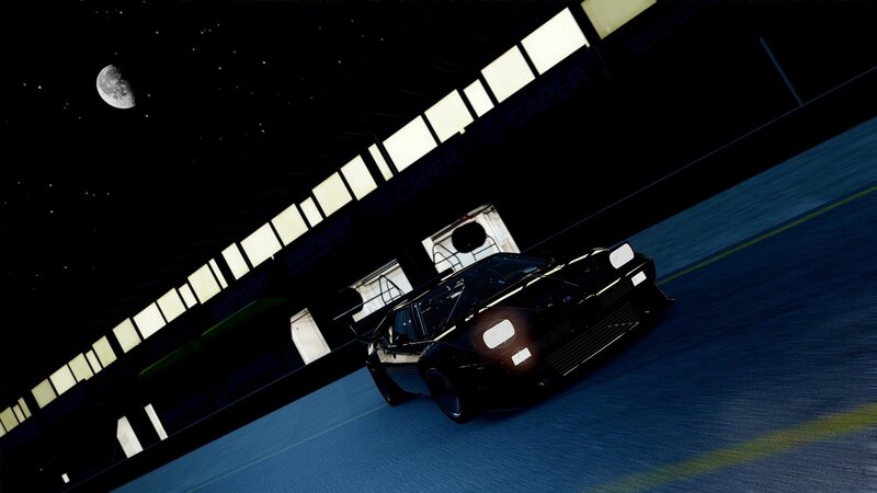 Black car on racetrack at night