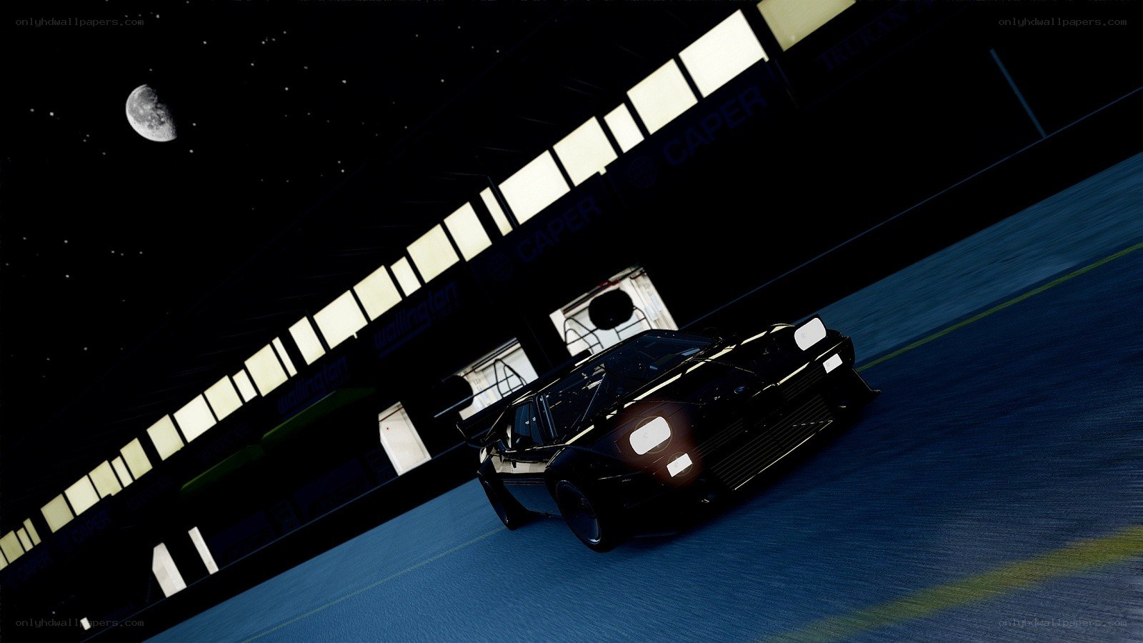 Black car on racetrack at night