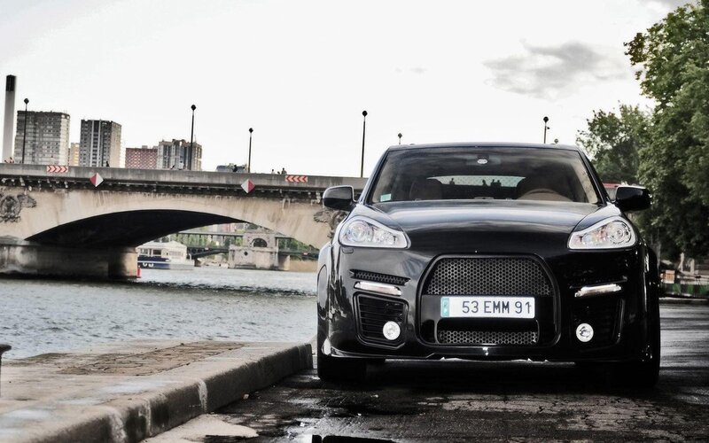Black car on riverbank
