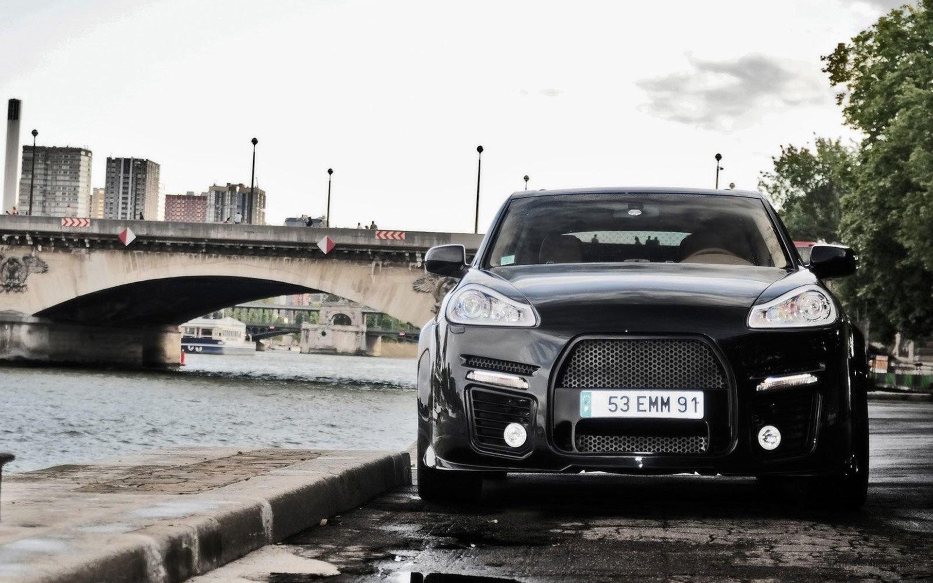 Black car on riverbank