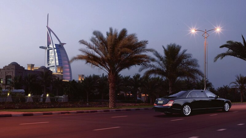 Black car on road at dusk