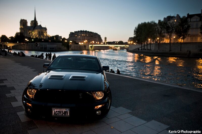 Black car on Seine at dusk