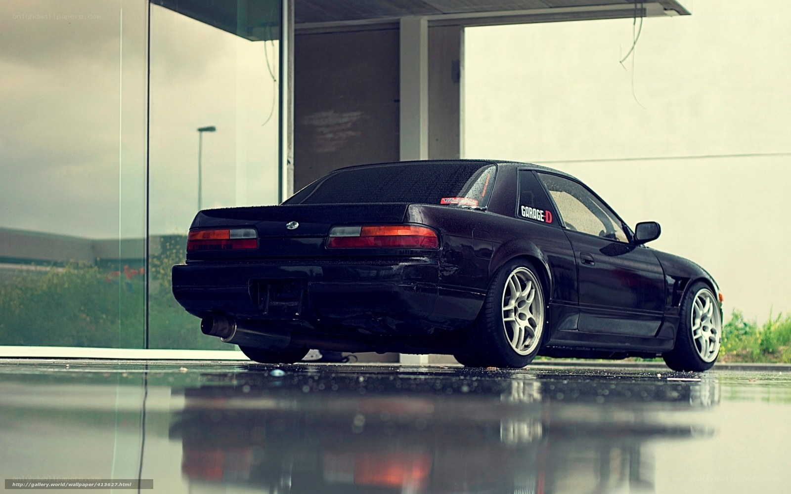 black car on wet pavement