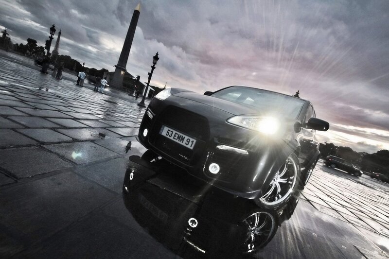 Black car on wet plaza in Paris