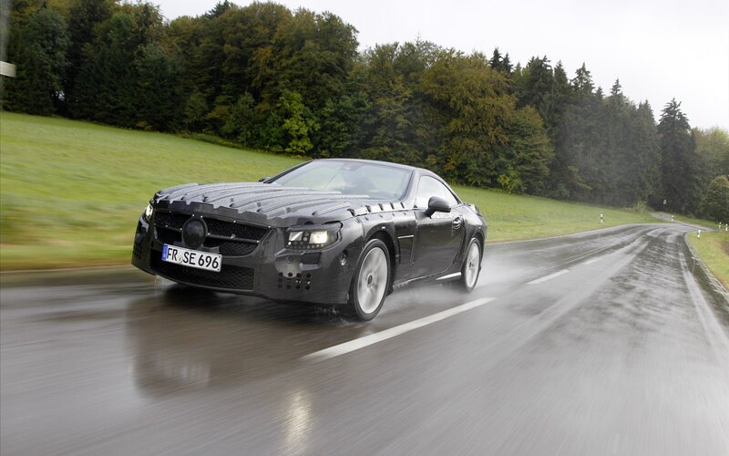 Black Car on Wet Road — Dynamic