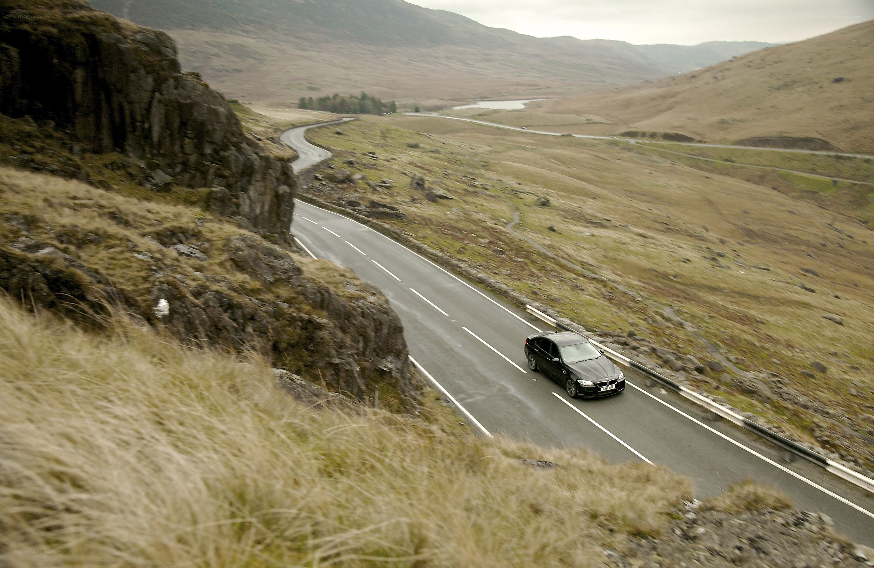 Black car on winding mountain road