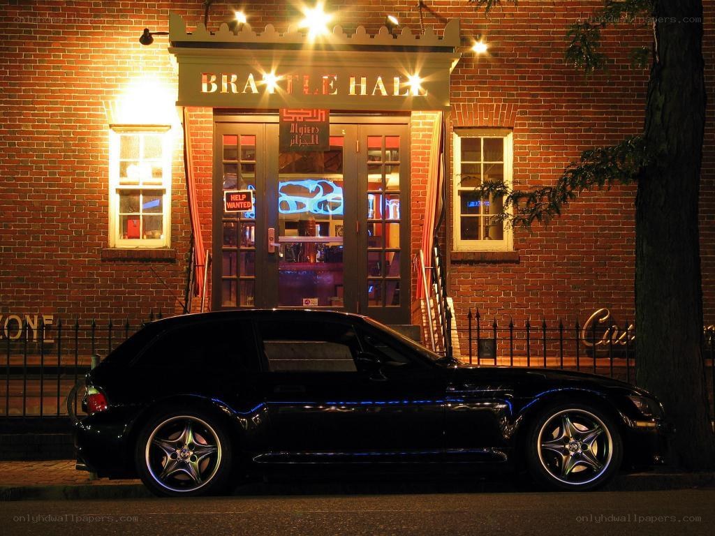 Black car outside Brattle Hall at night