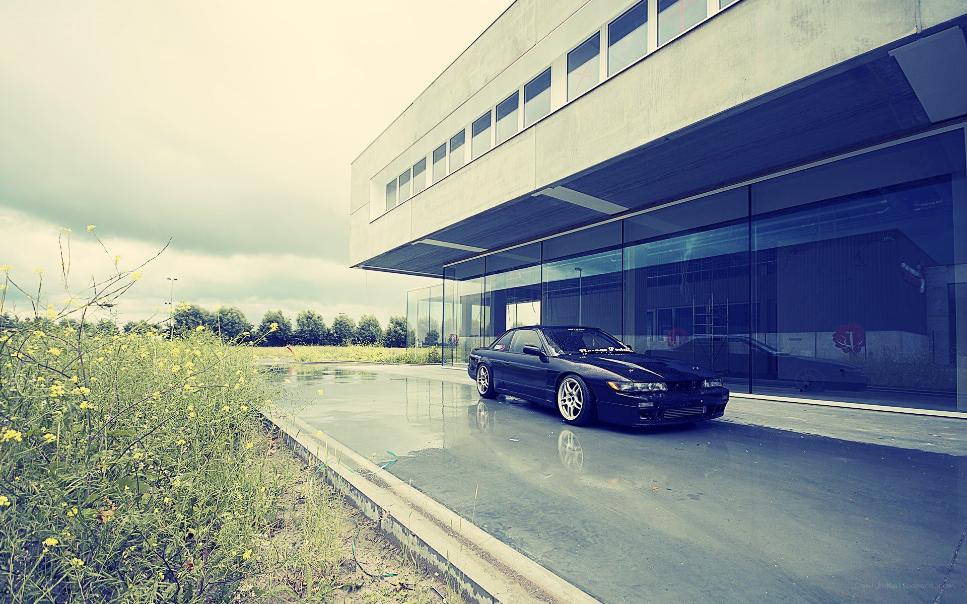 Black car parked outside modern building