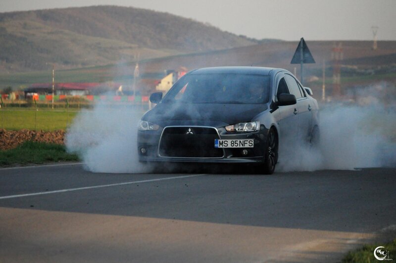Black car performing burnout