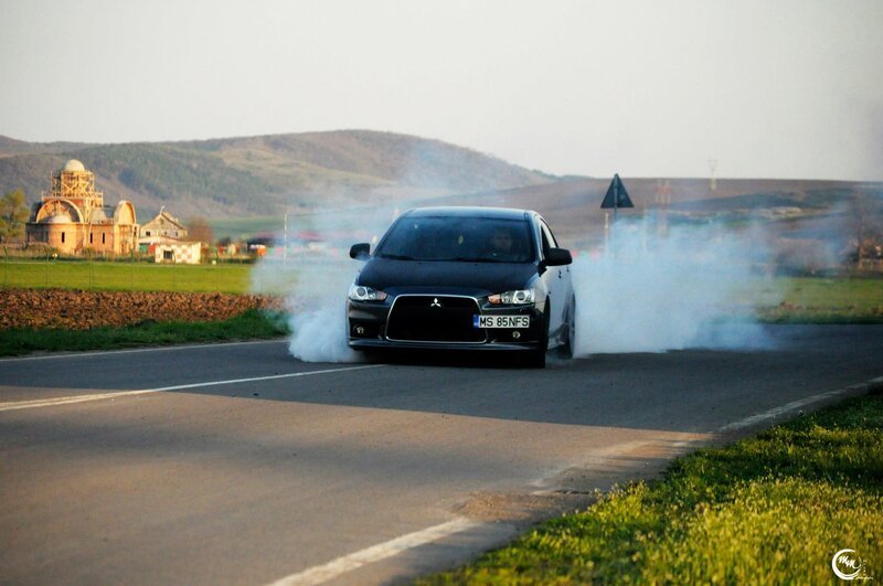 Black car performing burnout