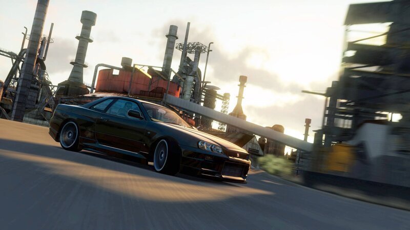 black car racing at industrial site