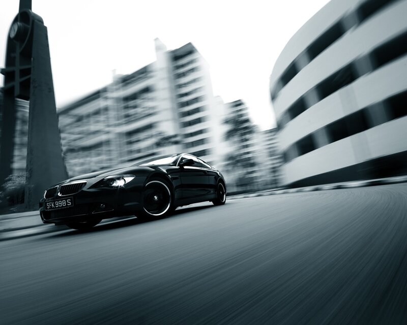 Black car speeding on city street