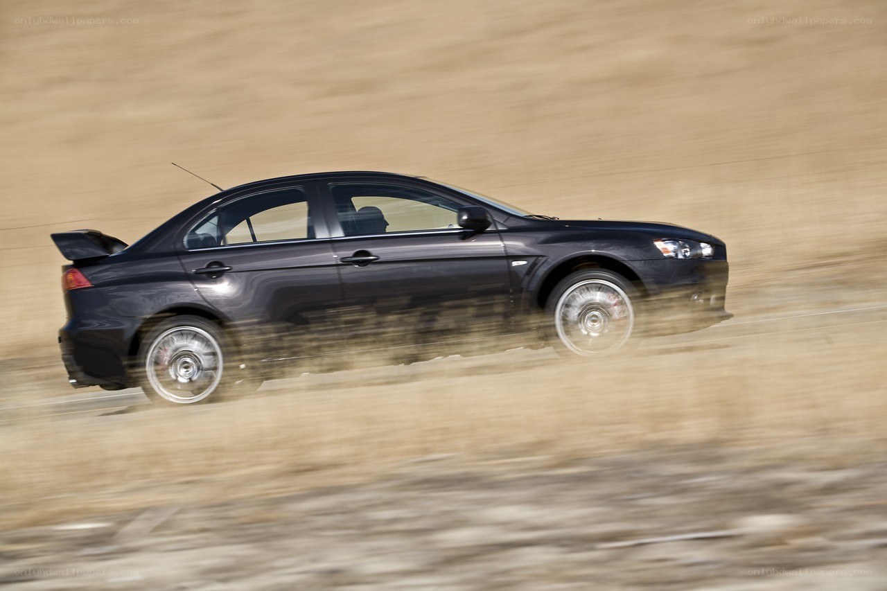 black car speeding on dirt