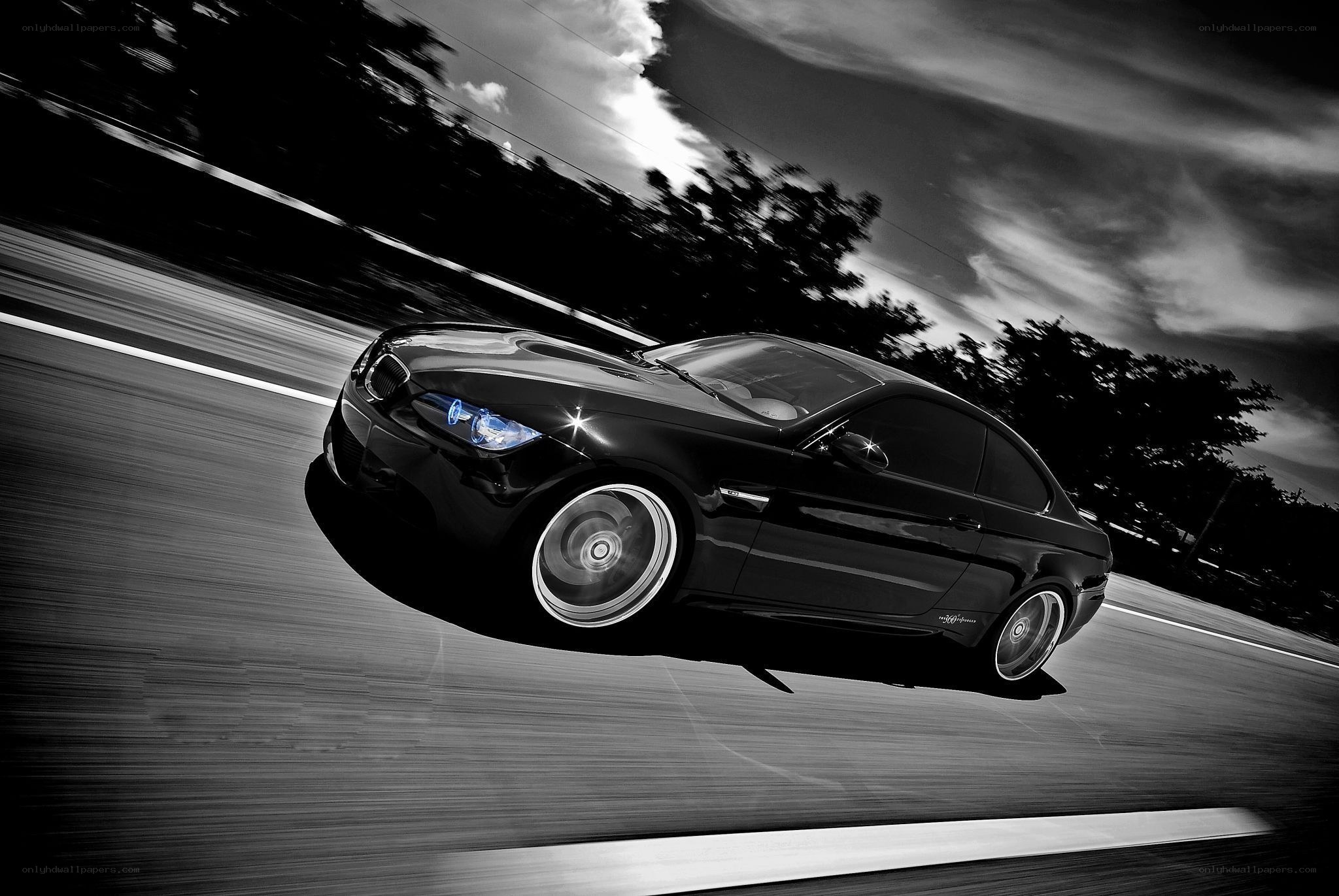 Black car speeding on road