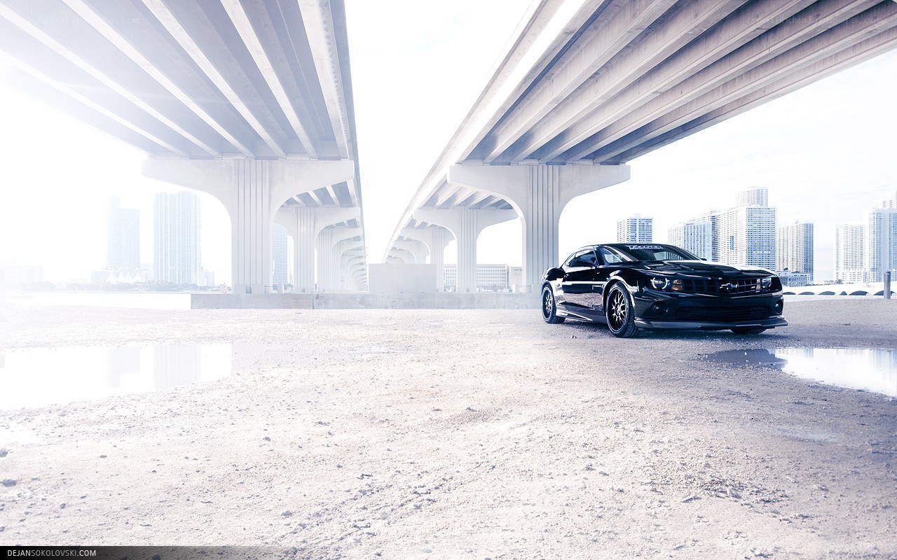 Black car under a bridge