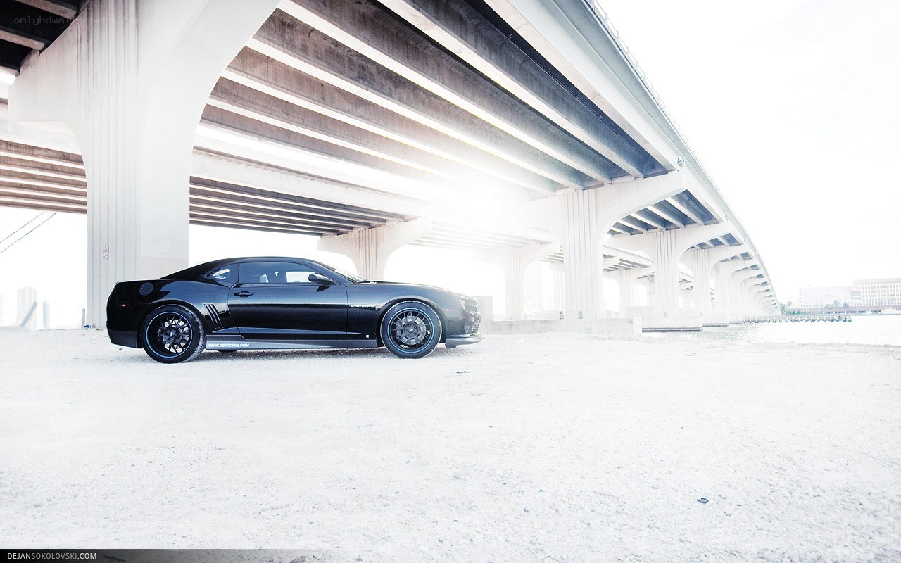 Black car under a bridge