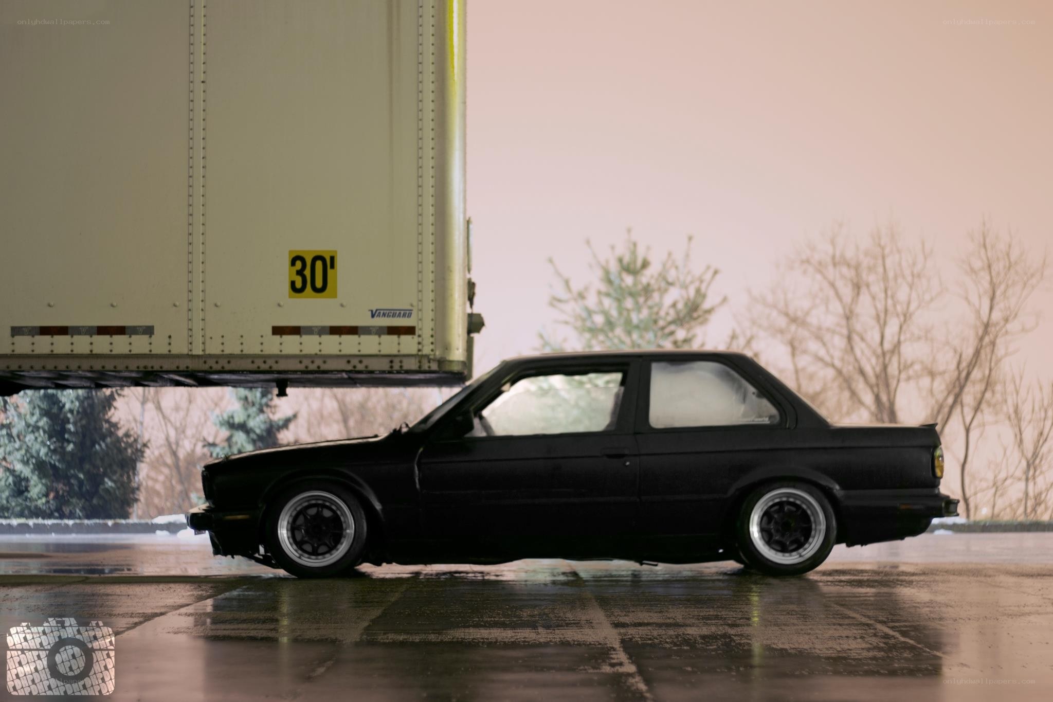 Black car under a semi-trailer