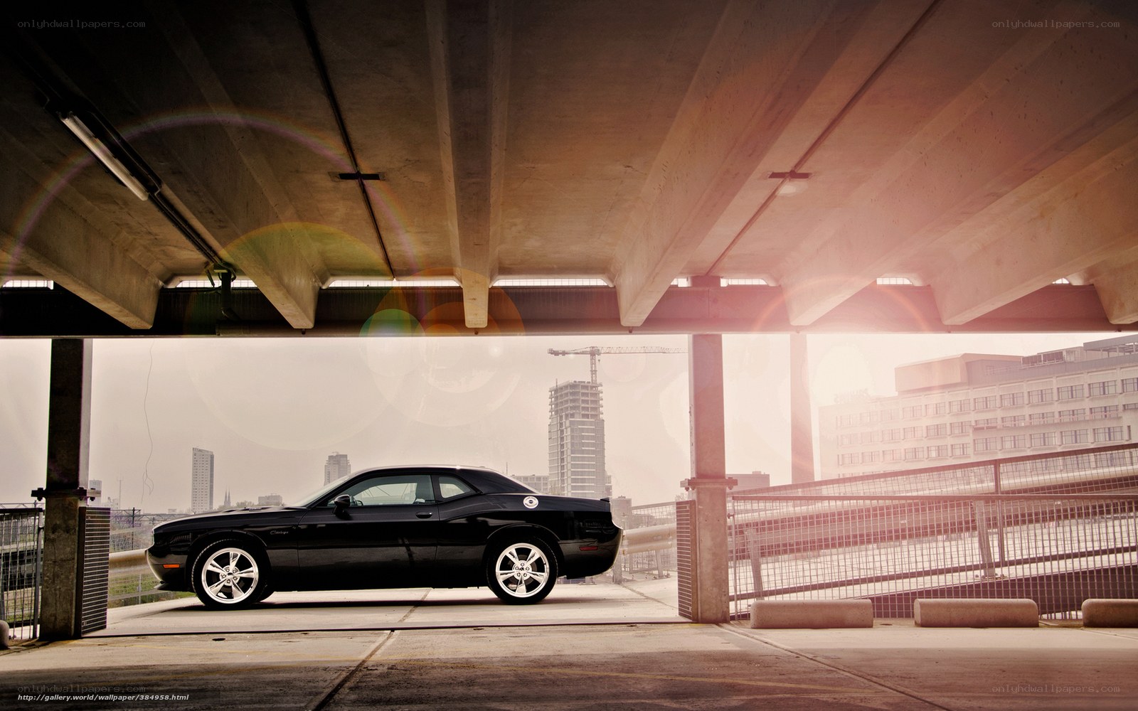 Black car under concrete bridge