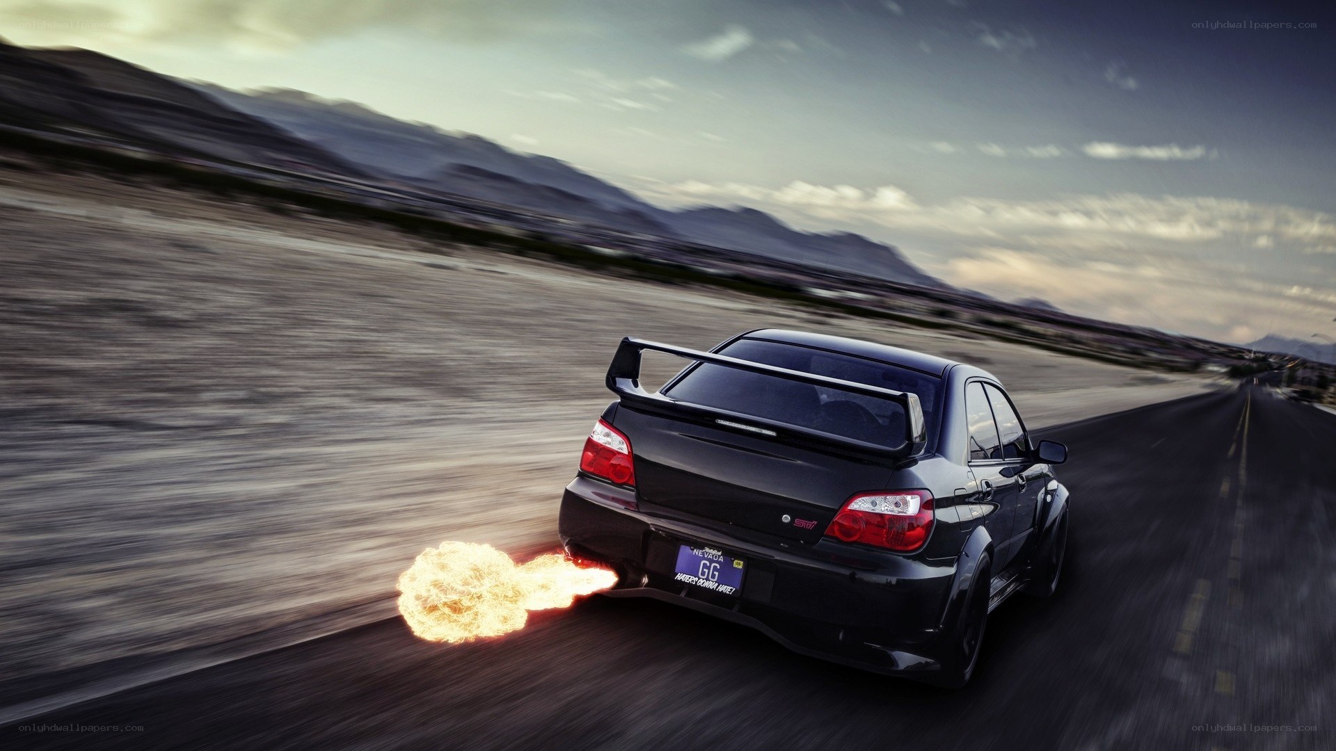 Black car with flames on road