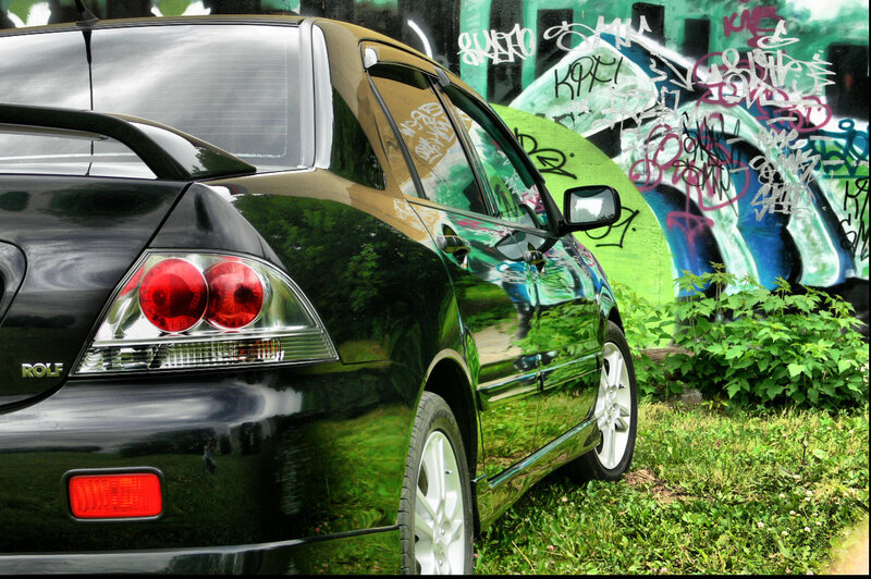 Black car with graffiti background