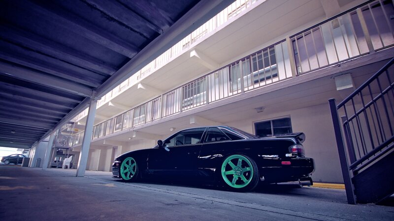 Black Car with Green Wheels — Dramatic