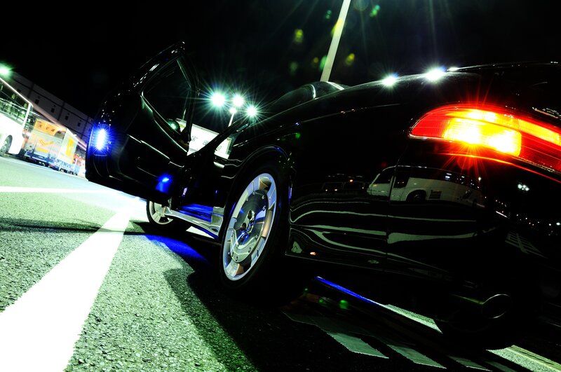 black car with open door at night