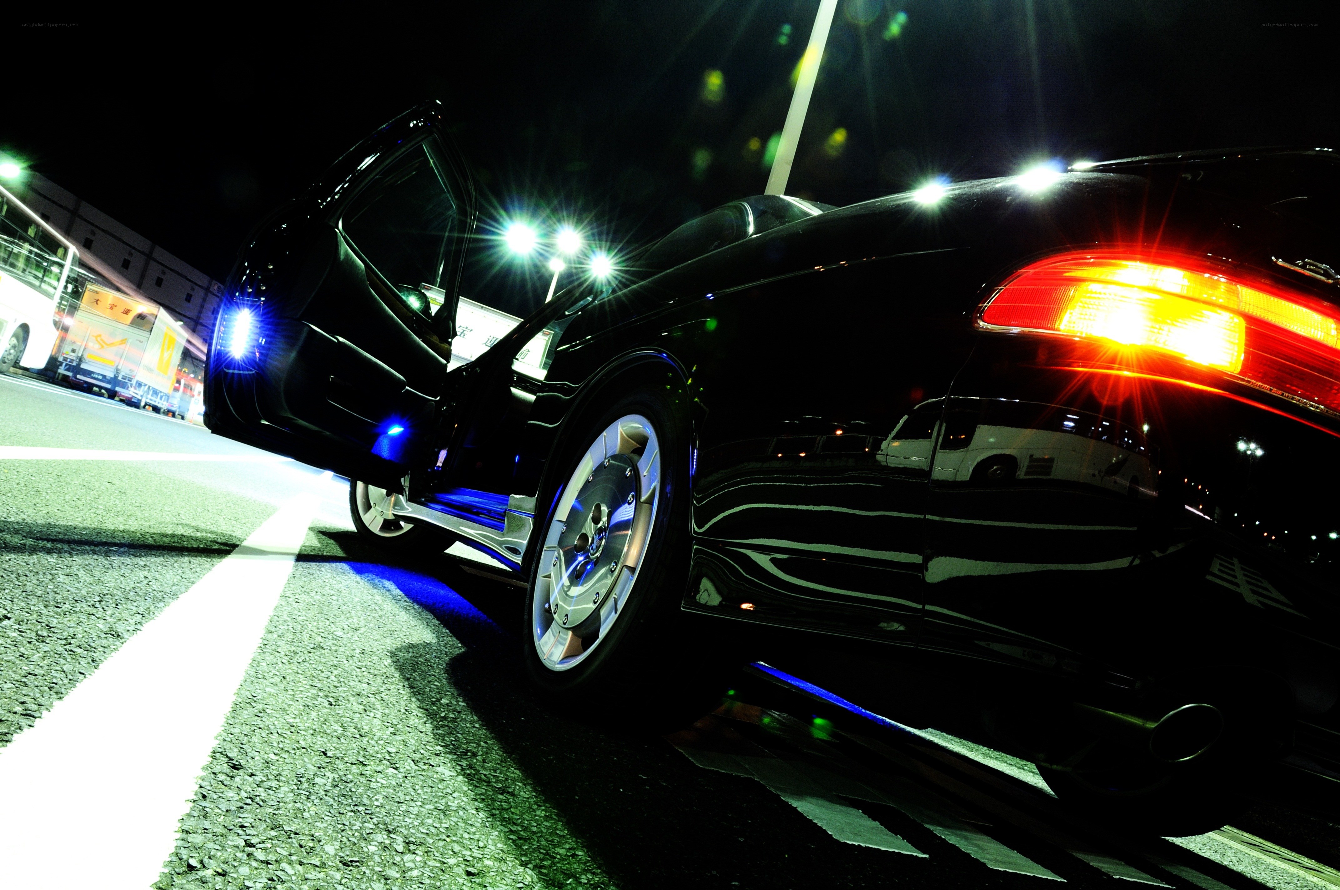 black car with open door at night